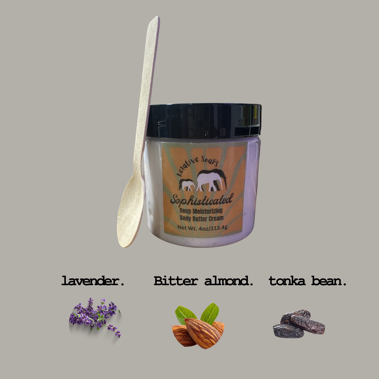 Jar of body butter cream with a wooden spoon on a gray background, featuring lavender, bitter almond, and tonka bean scents.