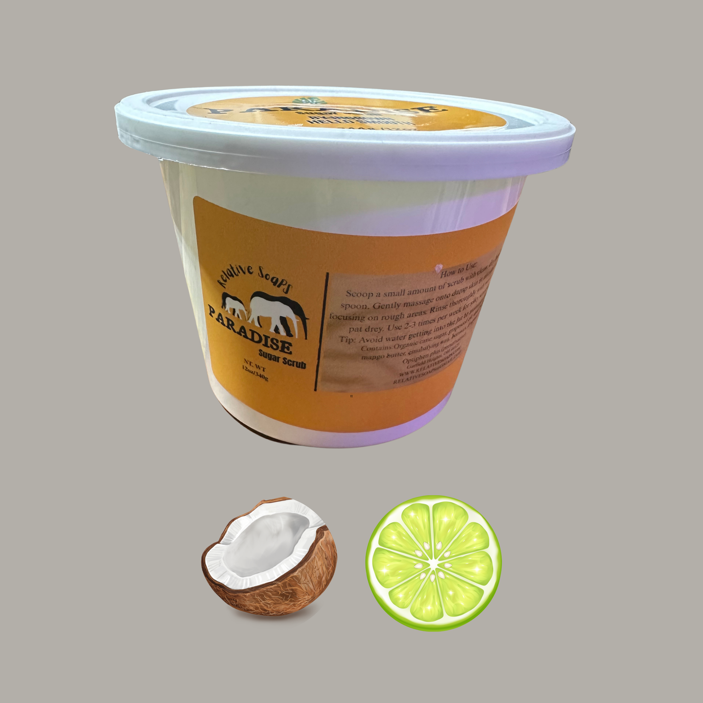 Container of coconut lime ice cream with a coconut and lime slice on a gray background