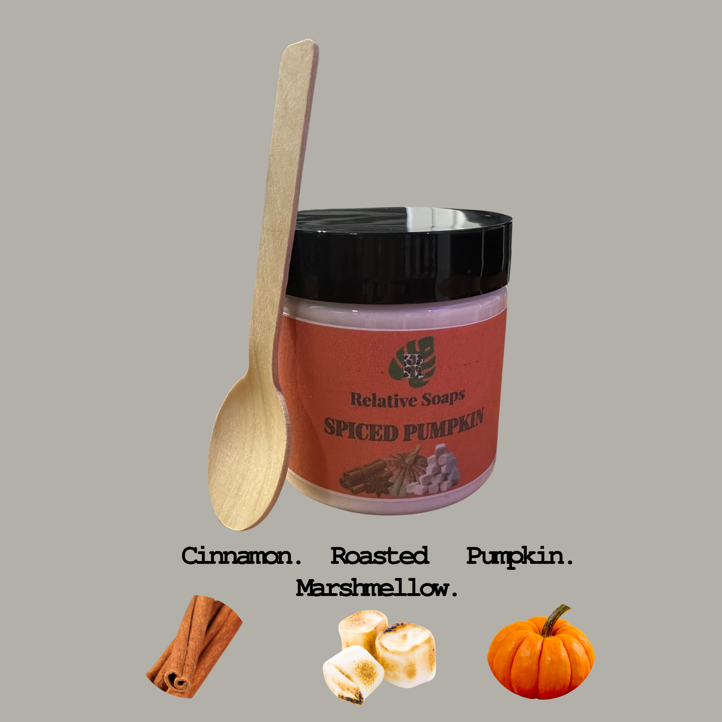 Jar of 'Spiced Pumpkin' soap with a wooden spoon and autumn-themed elements on a gray background